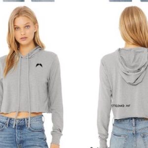 Female workout crop hoodie with strong statement